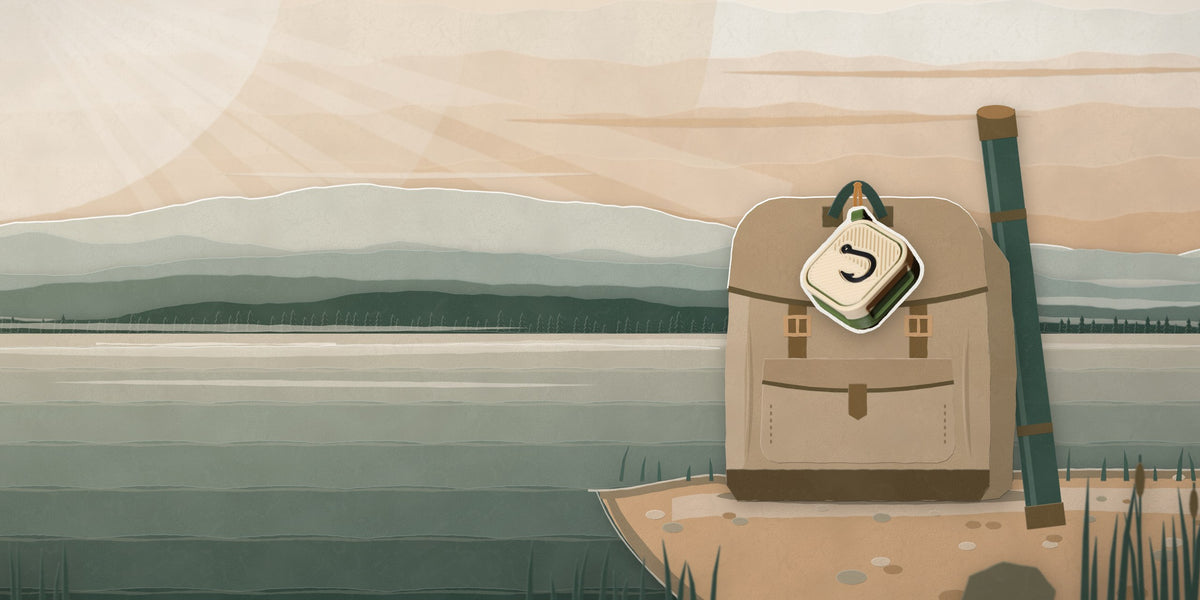 Fishing AirTag case keychain hanging from a tackle bag in a paper-cut sunset scene
